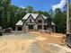 Front view of a brick home under construction with building wrap and stacked bricks at 67 Ridgeline Ct # 7, Pittsboro, NC 27312