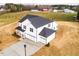 Aerial view of the new construction home with a three-car garage and a long driveway at 7417 Prato Ct, Wendell, NC 27591