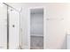 Bathroom with tiled shower, glass door, and access to a walk-in closet at 7417 Prato Ct, Wendell, NC 27591