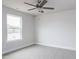 Bright bedroom featuring a ceiling fan and a large window showcasing the outdoor view at 7417 Prato Ct, Wendell, NC 27591