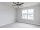 Cozy bedroom featuring neutral carpeting, ceiling fan, and a bright window at 7417 Prato Ct, Wendell, NC 27591