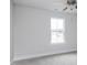 Bedroom with neutral carpeting, ceiling fan, and a bright window at 7417 Prato Ct, Wendell, NC 27591