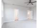 Spacious bedroom with neutral carpet, featuring multiple doors and a ceiling fan at 7417 Prato Ct, Wendell, NC 27591