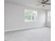 Bright bedroom featuring neutral carpet and large windows offering ample natural light at 7417 Prato Ct, Wendell, NC 27591