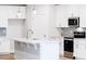 Beautiful kitchen with stainless steel appliances, white cabinets and a large island at 7417 Prato Ct, Wendell, NC 27591