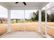Relaxing screened-in porch overlooking expansive backyard and distant buildings at 7417 Prato Ct, Wendell, NC 27591