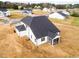 View of rear exterior of new construction home with a screened-in porch and large yard at 7417 Prato Ct, Wendell, NC 27591