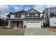 Charming two-story home with stone accents, a two-car garage, and a well-manicured lawn at 225 Hopewell Branch Ct, Smithfield, NC 27577