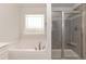 Main bathroom featuring a soaking tub and tiled shower at 225 Hopewell Branch Ct, Smithfield, NC 27577