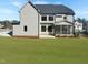 Wide backyard of home showing lawn, screened in porch and patio at 2525 Silas Peak Ln, Apex, NC 27523