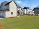 View of the backyard, adjacent home and screened-in porch at 2525 Silas Peak Ln, Apex, NC 27523