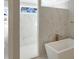 Bright bathroom features marble-look tile shower, free standing tub and a sunny window at 2525 Silas Peak Ln, Apex, NC 27523