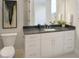 Bathroom with granite countertops, white cabinetry, and modern fixtures at 2525 Silas Peak Ln, Apex, NC 27523