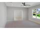 Bright bedroom features large windows, an open doorway, and neutral carpeting at 2525 Silas Peak Ln, Apex, NC 27523