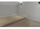 A bright bedroom space with neutral paint and carpeting, enhanced by modern lighting at 2525 Silas Peak Ln, Apex, NC 27523