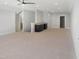 Spacious bonus room is lit with recessed lights and features a modern ceiling fan and wet bar at 2525 Silas Peak Ln, Apex, NC 27523