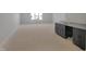 A large bonus room features a stylish wet bar, plush carpeting, and lots of natural light at 2525 Silas Peak Ln, Apex, NC 27523