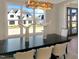 Bright dining area with modern chandelier and large windows offering pleasant outdoor views at 2525 Silas Peak Ln, Apex, NC 27523