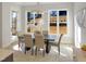 Bright dining room with modern chandelier, rug, and views of the backyard at 2525 Silas Peak Ln, Apex, NC 27523