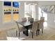 Sunlit dining room with modern chandelier, rug, and views of the backyard at 2525 Silas Peak Ln, Apex, NC 27523