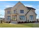 Stunning two-story home featuring a light brick exterior and dark trim on a well-manicured lawn at 2525 Silas Peak Ln, Apex, NC 27523