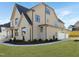 Beautiful home featuring attached garage, stone accents, green lawn, and attractive landscaping at 2525 Silas Peak Ln, Apex, NC 27523