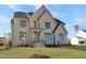 Attractive two-story home with light brick and contrasting dark trim, complemented by a well-maintained lawn at 2525 Silas Peak Ln, Apex, NC 27523