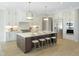 Modern kitchen with island, stainless steel appliances, and white cabinets at 2525 Silas Peak Ln, Apex, NC 27523