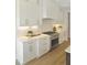 Modern kitchen with stainless steel stove and white cabinets at 2525 Silas Peak Ln, Apex, NC 27523