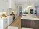 Bright kitchen featuring white cabinets, stainless appliances, and a large kitchen island at 2525 Silas Peak Ln, Apex, NC 27523