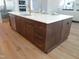 Gourmet kitchen island with white countertop, wood cabinets, and gold hardware at 2525 Silas Peak Ln, Apex, NC 27523