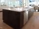 Kitchen island with sink, dishwasher, and seating at 2525 Silas Peak Ln, Apex, NC 27523