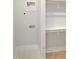 Bright laundry room with white tile flooring, utility hookups and access to open, white shelving at 2525 Silas Peak Ln, Apex, NC 27523