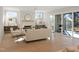 Bright living room with fireplace, hardwood floors, and sliding glass doors to patio at 2525 Silas Peak Ln, Apex, NC 27523