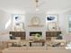 Bright living room with fireplace, hardwood floors, and stylish furniture at 2525 Silas Peak Ln, Apex, NC 27523