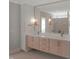 Modern main bathroom features a double vanity, sleek cabinets and bright, decorative lighting at 2525 Silas Peak Ln, Apex, NC 27523