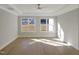 Large main bedroom with neutral paint, wood floors, tray ceilings and bright, sunny windows at 2525 Silas Peak Ln, Apex, NC 27523