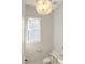 Stylish powder room with decorative lighting fixture and neutral decor at 2525 Silas Peak Ln, Apex, NC 27523