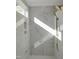 Bright shower with marble-look tiles, built-in shelving and dual shower heads at 2525 Silas Peak Ln, Apex, NC 27523