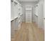Large walk-in closet boasts wood floors, built-in shelving and cabinets on all sides at 2525 Silas Peak Ln, Apex, NC 27523
