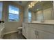 Bathroom featuring a double vanity with white cabinets, quartz countertop, and modern lighting at 321 Murray Grey Ln, Wake Forest, NC 27587