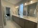 Bathroom featuring double vanity sinks with large mirrors, recessed lighting, and neutral tones at 321 Murray Grey Ln, Wake Forest, NC 27587