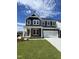 Beautiful two-story home with a stone and siding exterior, well-manicured lawn, and attached two-car garage at 321 Murray Grey Ln, Wake Forest, NC 27587