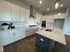 Kitchen showcasing white cabinets, stainless steel appliances, a central island, and modern fixtures at 321 Murray Grey Ln, Wake Forest, NC 27587