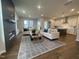 Living room with a fireplace, plush sofas, an open floorplan, and bright, natural light at 321 Murray Grey Ln, Wake Forest, NC 27587