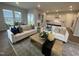 Open-concept living room featuring hardwood floors, plush sofas, and large windows for ample natural light at 321 Murray Grey Ln, Wake Forest, NC 27587