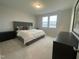 Well-lit main bedroom with plush carpet, furnishings, and large windows at 321 Murray Grey Ln, Wake Forest, NC 27587