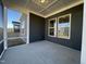 Covered porch featuring a neutral color palette, a view of the backyard, and contemporary ceiling details at 321 Murray Grey Ln, Wake Forest, NC 27587