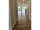 Hallway view leading to a bright living area with wood-look flooring and staircase on the right at 104 Gin Branch Rd, Wendell, NC 27591