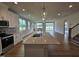 Open-concept kitchen featuring a large island with quartz countertops, white cabinets, and stainless steel appliances at 104 Gin Branch Rd, Wendell, NC 27591
